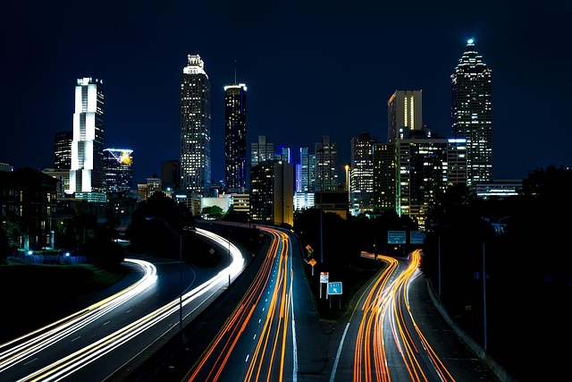 Atlanta Georgia travel guide featuring the downtown Atlanta skyline at night with light trails from the highway