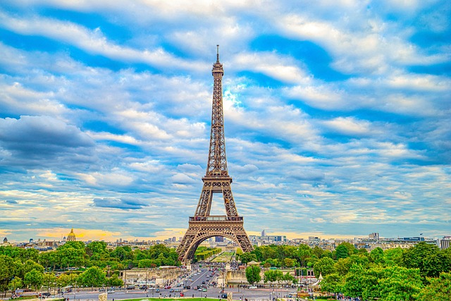 Paris travel guide image of the Eiffel Tower with the Paris skyline and dramatic blue sky